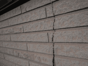 Vertical crack in brick exterior wall indicating possible foundation movement