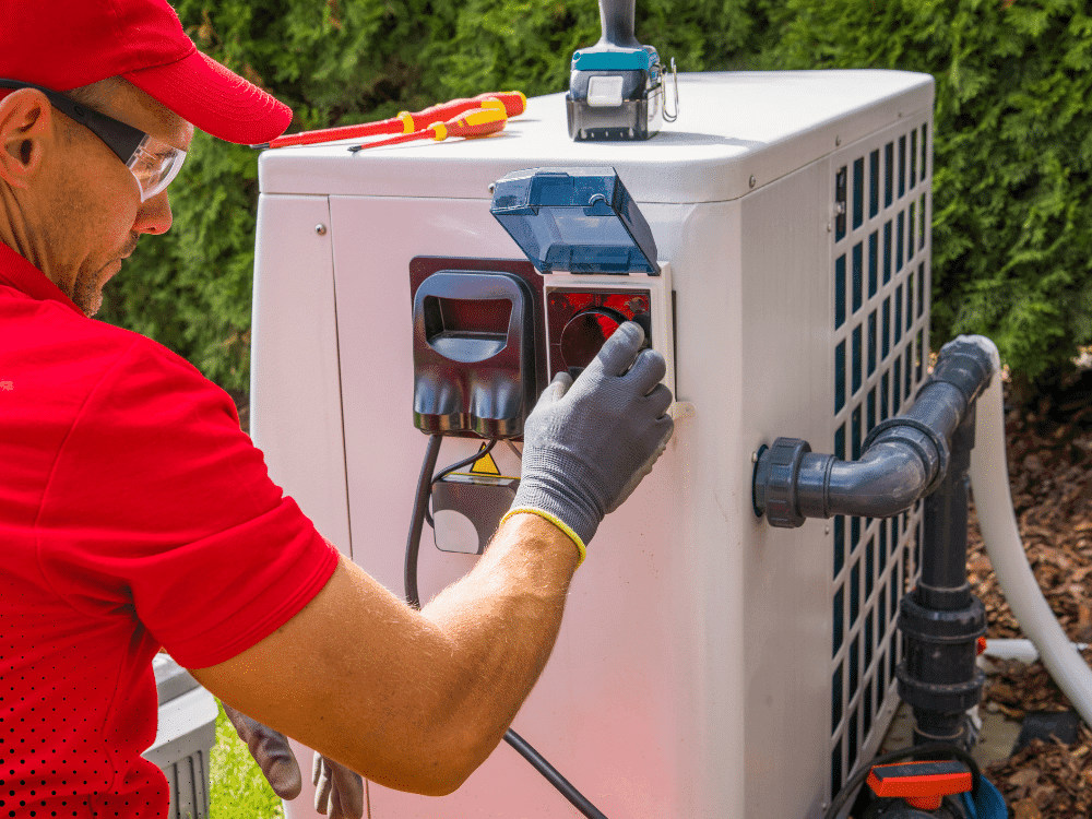 Technician inspecting and testing electrical panel on outdoor AC condenser unit