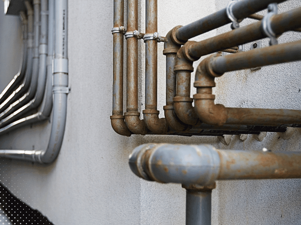 Aging plumbing pipes with visible rust reviewed during an older home inspection in Lafayette, LA